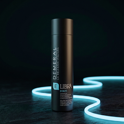 immagine prodotto Libra, flacone nero con elementi azzurri. Poggia su sfondo nero con neon azzurri